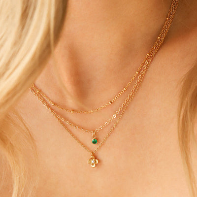 Woman wearing gold dainty necklaces