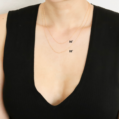 Woman wearing gold dainty chain necklace
