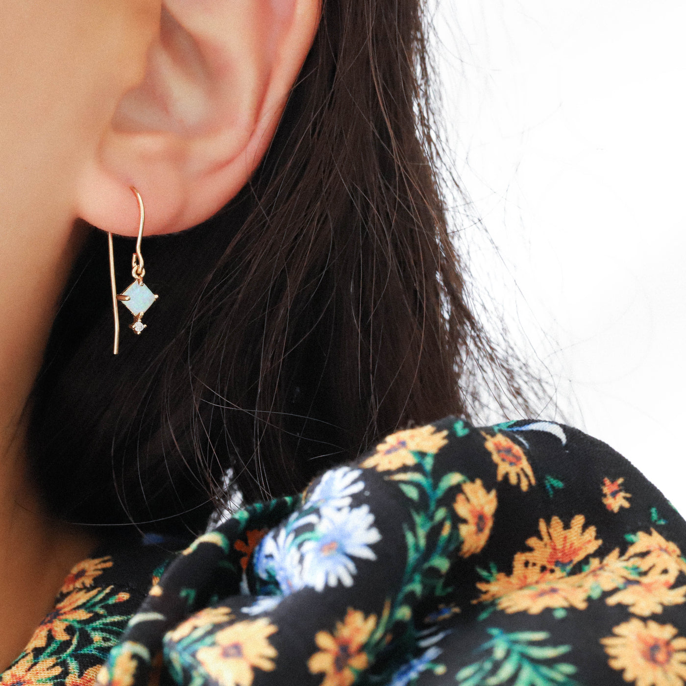 Woman wearing a gold opal earring